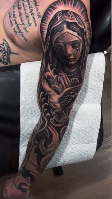 Black and grey religious realism sleeve with a tearful figure and dove